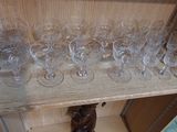 many empty glasses on a shelf in a room