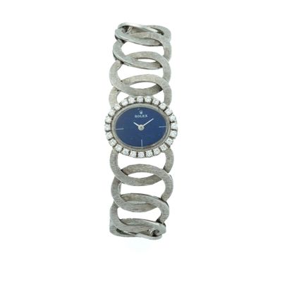 an image of a woman ' s wrist watch with a blue dial