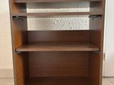 an image of a wooden bookcase with two shelves