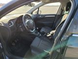 the interior of a car with the door open and the driver ' s seat down