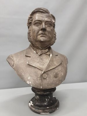 a close up of a bust of a man wearing a suit