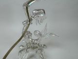 a glass figurine of a flower with a long stem