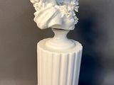 an image of a white statue of a woman with flowers on her head