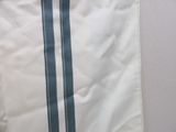 a white bag with a blue stripe hanging on a wall