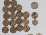 a lot of coins that are on a white surface