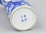 a blue and white vase sitting on a table