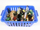 a blue basket full of beer bottles on a white table