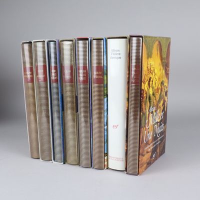 several books are stacked on top of each other on a table