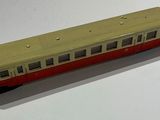 a red and white train car on a white surface