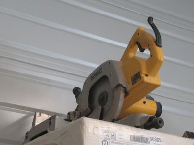 a circular saw on top of a box on a shelf
