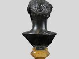a bronze bust of a man on a pedestal