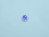 a purple sapphire stone on a white surface