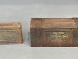 an old metal box and a small metal box sitting on a table