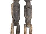 pair of carved wooden figures of a man and a woman