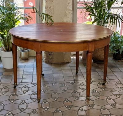 a wooden table that is sitting on a tiled floor