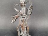 statue of a woman holding a fish in her right hand
