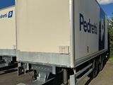 two semi trailers that are parked in a parking lot