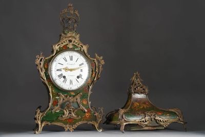 two clocks sitting next to each other on a table