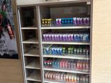a display case with drinks in it inside of a store