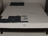 a bed that has a mattress on it in a room