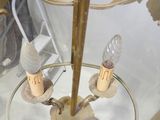 a glass and brass clock with a clock face on it
