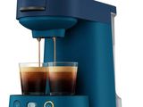 a close up of a coffee maker with two cups of coffee