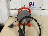 an orange and black hose sitting on top of a table next to a sign