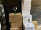 boxes stacked on top of each other with a glass of wine on top