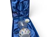 a blue gift box with a glass vase and a candle in it