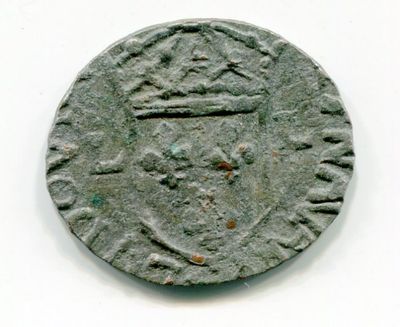 an old coin with a crown on it sitting on a white surface