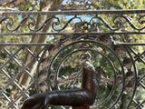 a statue of a horse on a table in front of a window