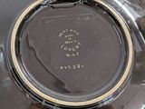 a close up of a black bowl with a brown lid