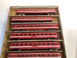 six red trains sitting in a box on a table