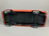 a close up of a toy car on a white surface