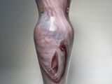 a vase that is sitting on a white surface
