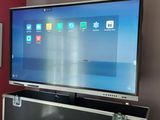 a large flat screen tv on a stand in a living room