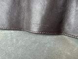 a close up of a black leather wallet on a green surface