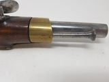 a close up of a gun on a white surface