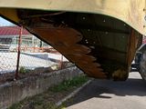 a large yellow boat sitting on the side of the road