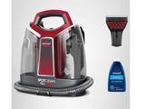 a close up of a vacuum cleaner and a bottle of cleaner