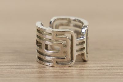 a silver ring with a square design on it