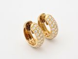 a pair of gold and diamond hoop earrings