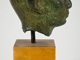 an image of a sculpture of a head on a marble block