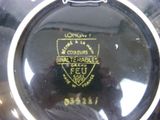 a close up of a black plate with a gold emblem on it