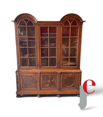 a wooden china cabinet with glass doors on it