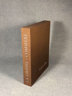 a brown book sitting on top of a table next to a gray wall
