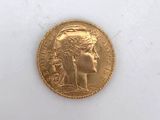 a close up of a gold coin on a white surface