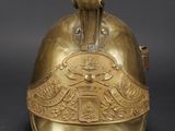 an old brass helmet with a bird on the top of it