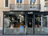 a store front with a sign on the side of the building