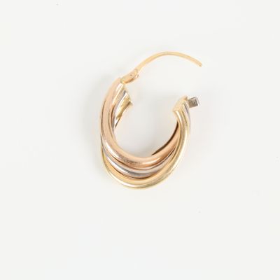 a close up of a pair of gold hoop earrings on a white surface